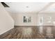 Living room featuring hardwood floors, natural light, and a stairwell at 4528 Potters Glen Rd, Charlotte, NC 28269