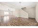 Living room featuring hardwood floors, natural light, and a stairwell at 4528 Potters Glen Rd, Charlotte, NC 28269