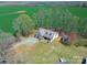 Aesthetic aerial view showcasing the property, expansive green field, and complementing outbuildings at 4605 Austin Rd, Monroe, NC 28112