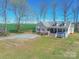 Aesthetic aerial view of the home, featuring a covered porch, manicured yard, and lush green surroundings at 4605 Austin Rd, Monroe, NC 28112