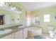 Bright bathroom featuring double sinks and a large soaking tub at 4605 Austin Rd, Monroe, NC 28112