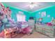 The bedroom has a vibrant teal color, lots of light and plenty of space at 4605 Austin Rd, Monroe, NC 28112