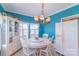 Cozy dining room with a round table, white chairs, and bright blue walls at 4605 Austin Rd, Monroe, NC 28112