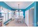 Bright dining room with a round table, white chairs, and a decorative chandelier at 4605 Austin Rd, Monroe, NC 28112