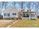 Inviting home featuring a charming front porch, well-maintained landscaping, and a serene, tree-lined property at 4605 Austin Rd, Monroe, NC 28112