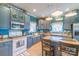 Charming kitchen featuring blue cabinets, modern appliances, and a cozy island with bar seating at 4605 Austin Rd, Monroe, NC 28112