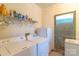 Bright laundry room with washer, dryer, shelving and exterior access at 4605 Austin Rd, Monroe, NC 28112