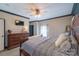 Comfortable main bedroom with a wooden dresser, TV, and cozy decorations at 4605 Austin Rd, Monroe, NC 28112