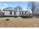 Backyard with a wooden deck, garden boxes, and mature trees at 5501 Joyce Dr, Charlotte, NC 28215
