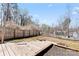 Spacious backyard with wooden fence and gardening boxes, perfect for outdoor activities at 5501 Joyce Dr, Charlotte, NC 28215