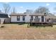 Spacious backyard with a deck, garden boxes, and mature landscaping at 5501 Joyce Dr, Charlotte, NC 28215