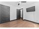 Bedroom featuring a large black door, black trim, ceiling fan and hardwood flooring at 5501 Joyce Dr, Charlotte, NC 28215