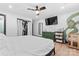 Bright bedroom featuring painted accent corner, hardwood floors, ceiling fan, and closet space at 5501 Joyce Dr, Charlotte, NC 28215