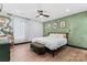 Stylish bedroom featuring a decorative accent wall, ceiling fan and lots of natural light at 5501 Joyce Dr, Charlotte, NC 28215