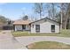 Charming single-story home with white siding, black trim, and lovely flower boxes under the windows at 5501 Joyce Dr, Charlotte, NC 28215