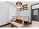 Charming kitchen nook with a wooden table, built-in bench, and modern light fixture at 5501 Joyce Dr, Charlotte, NC 28215