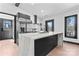 Bright, open kitchen with a large marble island and stainless steel refrigerator at 5501 Joyce Dr, Charlotte, NC 28215