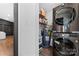 Organized laundry space with stacked washer/dryer and shelving for storage in a modern home at 5501 Joyce Dr, Charlotte, NC 28215