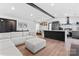 Open-concept living area with a white sectional sofa, kitchen, and dining nook at 5501 Joyce Dr, Charlotte, NC 28215
