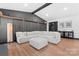 Spacious living room with a white sectional, hardwood floors, and modern decor at 5501 Joyce Dr, Charlotte, NC 28215
