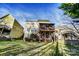 Spacious backyard featuring a two-story house with a screened deck, stairs, and beautiful landscaping at 5807 Mctaggart Ln, Charlotte, NC 28269