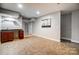 Finished basement with dark cabinets, tile floor, and neutral paint colors, perfect for entertaining at 5807 Mctaggart Ln, Charlotte, NC 28269