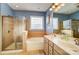 Bathroom with a double sink vanity, shower, and a separate bathtub, all with updated fixtures at 5807 Mctaggart Ln, Charlotte, NC 28269