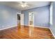 This bedroom offers hardwood floors, natural light from the windows and access to an attached bathroom at 5807 Mctaggart Ln, Charlotte, NC 28269