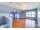 Expansive bonus room featuring hardwood floors, natural lighting, and stylish vaulted ceilings at 5807 Mctaggart Ln, Charlotte, NC 28269