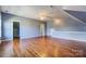 Large bonus room features hardwood floors, access to a closet, and stylish vaulted ceilings at 5807 Mctaggart Ln, Charlotte, NC 28269