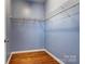 Walk-in closet with wooden floors and wire shelving for optimal storage, ready for personal organization at 5807 Mctaggart Ln, Charlotte, NC 28269
