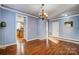 Dining area with hardwood floors, chandelier, and easy access to the kitchen, perfect for Gathering meals at 5807 Mctaggart Ln, Charlotte, NC 28269