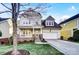 Charming two-story home with a well-manicured lawn, stone accents, and an attached two-car garage at 5807 Mctaggart Ln, Charlotte, NC 28269