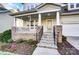 Inviting front porch featuring stone columns, stylish railings, and a welcoming entrance to the home at 5807 Mctaggart Ln, Charlotte, NC 28269