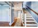 Bright hallway with hardwood floors, a staircase, and neutral paint, creating a welcoming entry space at 5807 Mctaggart Ln, Charlotte, NC 28269