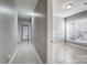 Neutral hallway leading into a room with natural light streaming through large windows at 5807 Mctaggart Ln, Charlotte, NC 28269