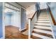 Elegant hallway with hardwood floors, a staircase, and classic trim, providing a seamless flow at 5807 Mctaggart Ln, Charlotte, NC 28269
