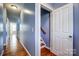 Hallway leading to the staircase and other rooms showcases wooden floors and light blue walls at 5807 Mctaggart Ln, Charlotte, NC 28269