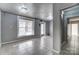 Spacious living room with neutral walls, tiled floors, recessed lighting, and a large window for natural light at 5807 Mctaggart Ln, Charlotte, NC 28269