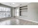Inviting room with tile floors and large windows, complemented by built-in shelving at 5807 Mctaggart Ln, Charlotte, NC 28269