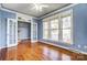 Spacious room with hardwood floors, bright light, offering comfort and style at 5807 Mctaggart Ln, Charlotte, NC 28269