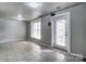 Bright living room with large windows, tiled floors, recessed lights, and a door to the outside at 5807 Mctaggart Ln, Charlotte, NC 28269