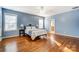 Bright, spacious main bedroom with hardwood floors, large windows, and an ensuite bathroom entrance at 5807 Mctaggart Ln, Charlotte, NC 28269