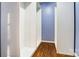 Empty walk-in closet with built-in shelving and hardwood floors, offering ample storage space at 5807 Mctaggart Ln, Charlotte, NC 28269