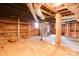 Unfinished basement featuring exposed brick walls, utility pipes, and concrete flooring at 610 Hawthorne Ln, Charlotte, NC 28204