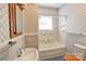 Bathroom with a shower-tub combo, pedestal sink, and floral wallpaper at 610 Hawthorne Ln, Charlotte, NC 28204