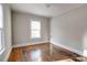 Bedroom featuring hardwood floors, neutral walls, and natural light from a window at 610 Hawthorne Ln, Charlotte, NC 28204