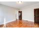 Bedroom featuring hardwood floors, neutral walls, and two doors at 610 Hawthorne Ln, Charlotte, NC 28204