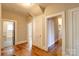 Hallway featuring hardwood floors and access to multiple rooms, including a bathroom with black trim at 610 Hawthorne Ln, Charlotte, NC 28204