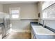 Kitchen featuring lots of natural light, double sinks, and stainless steel refrigerator at 610 Hawthorne Ln, Charlotte, NC 28204